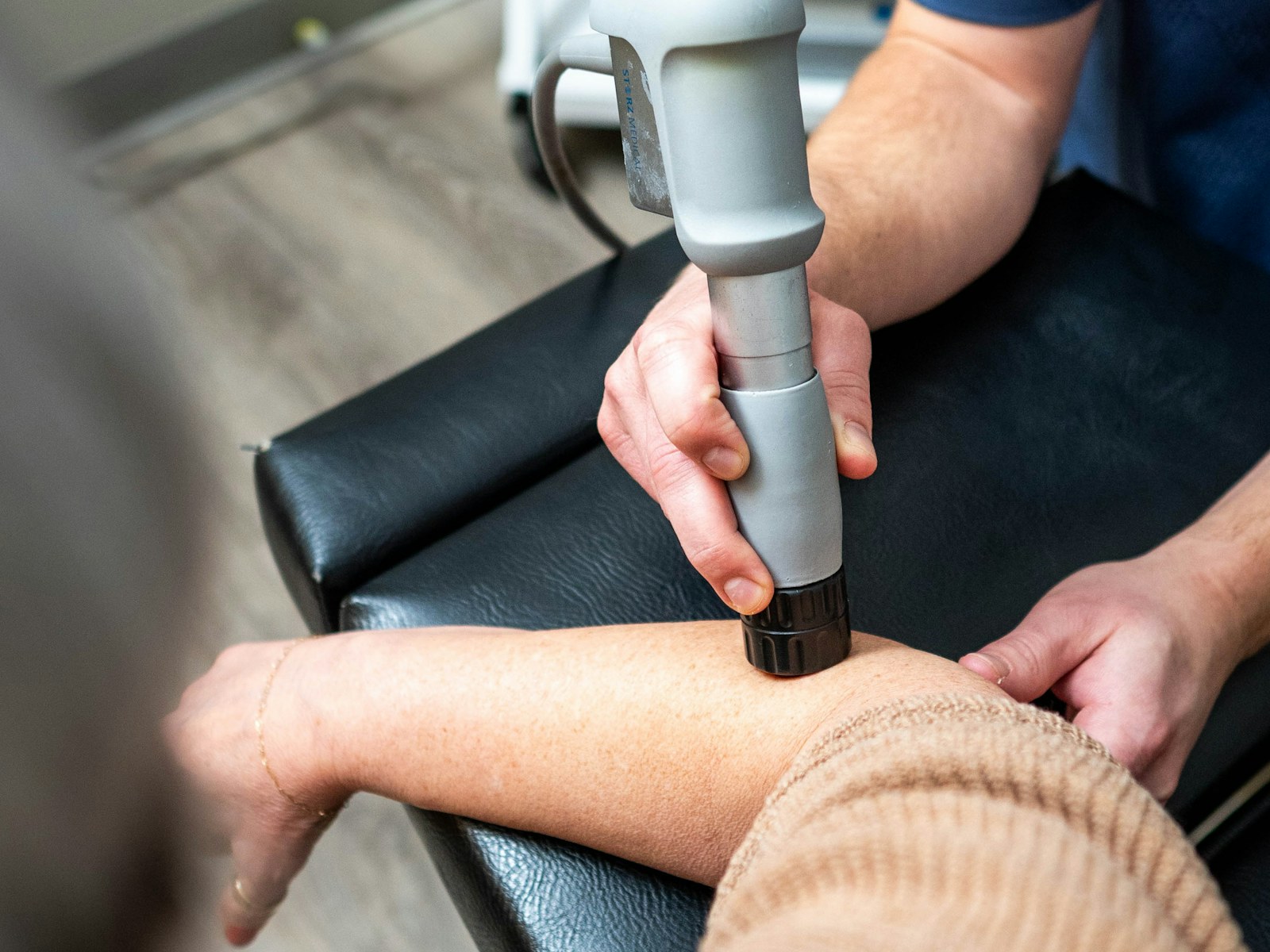 A therapist treats a patient's arm