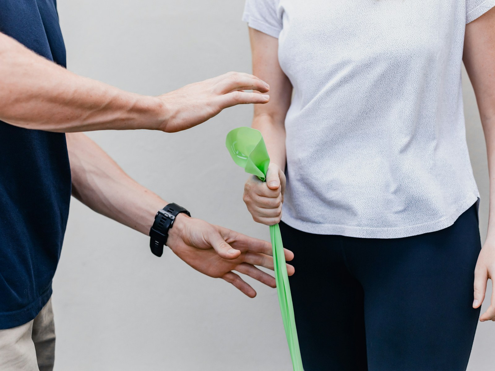A patient squeezing a therapy ball to build grip strength