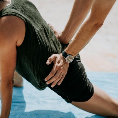 A therapist applies hands-on treatment to a man's back