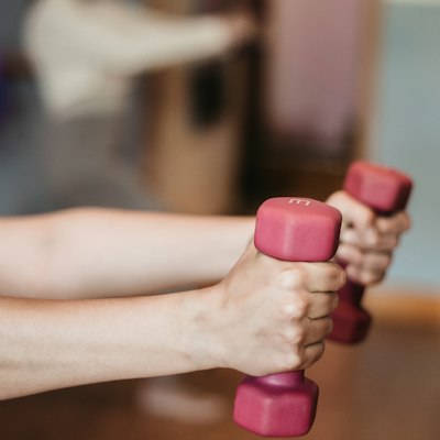 Hands holding light dumbbells